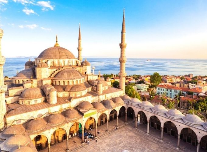 Interior view of the ornate Blue Mosque in Istanbul, showcasing intricate Islamic architecture with elegant blue tiles and ornamental details.