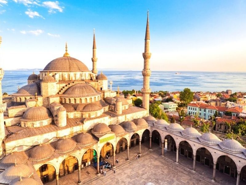 Interior view of the ornate Blue Mosque in Istanbul, showcasing intricate Islamic architecture with elegant blue tiles and ornamental details.