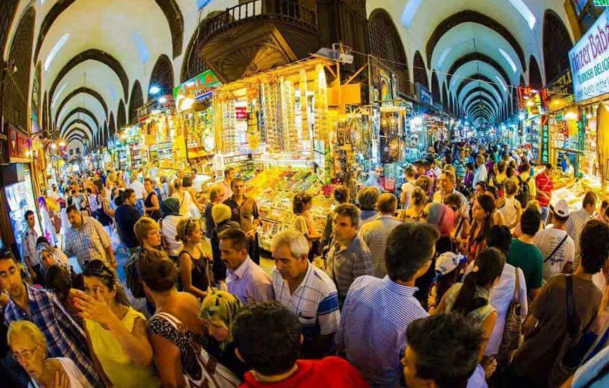 nterior view of Istanbul's Spice Bazaar, showcasing vibrant stalls with various spices, nuts, and colorful goods.