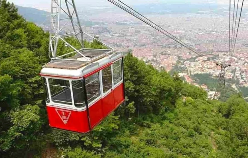 Cable car (teleferik) ascending Uludağ Mountain in Bursa, surrounded by forested slopes.