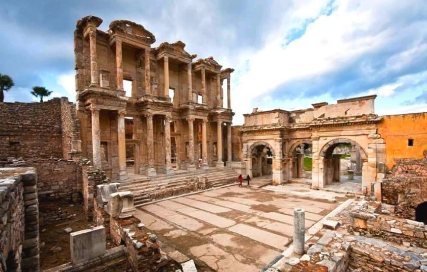 Exterior view of the Celsus Library in Ephesus, Turkey, showcasing its grand facade with marble columns and statues.