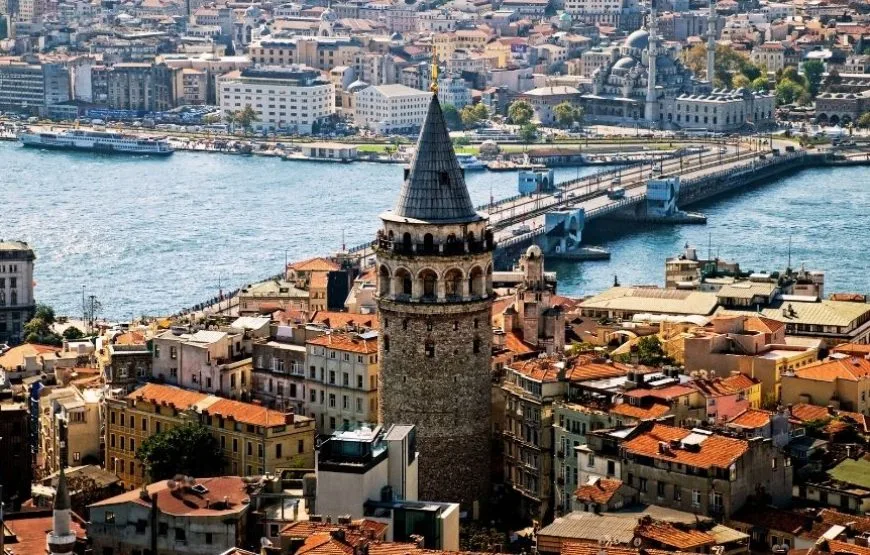 The historic Galata Tower in Istanbul, illuminated against the sky.