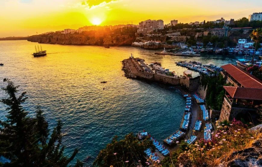 A serene view of a sandy beach and turquoise waters in Antalya.