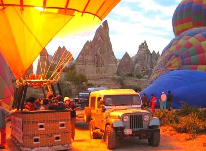 Hot air balloon launching in Cappadocia, with colorful balloons against the early morning sky