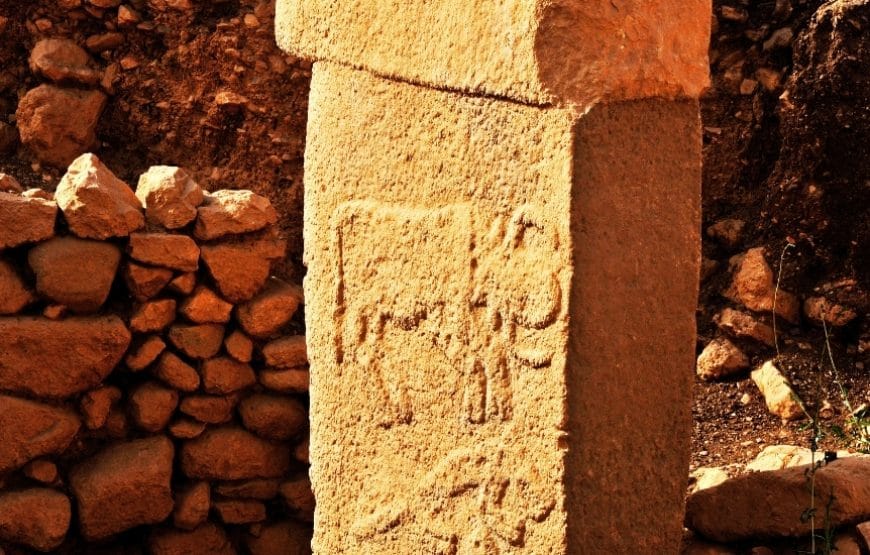 Intricately carved T-shaped pillar in Gobeklitepe, featuring animal reliefs from 12,000 years ago.