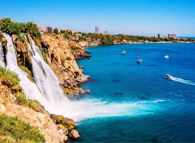 Scenic view of Düden Waterfall cascading into lush greenery in Antalya, Turkey.