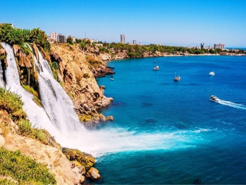 Scenic view of Düden Waterfall cascading into lush greenery in Antalya, Turkey.
