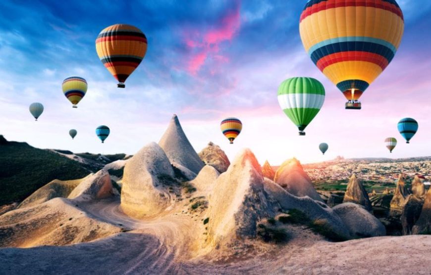 Hot air balloons soaring over Cappadocia’s valleys during sunrise, offering a magical aerial view.